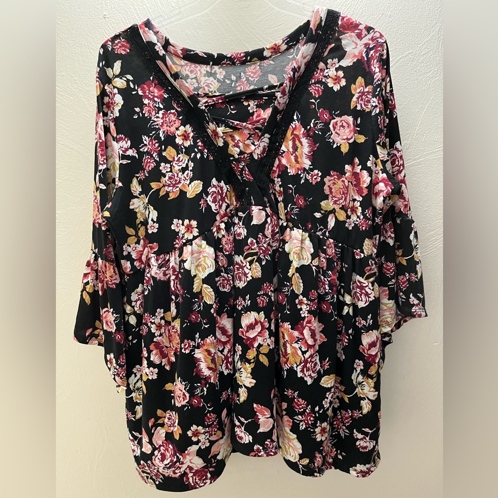 Floral top with bell sleeves in 2X.